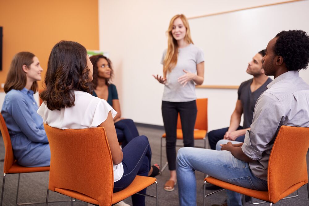 Group therapy session at an IOP facility with participants seated in a circle